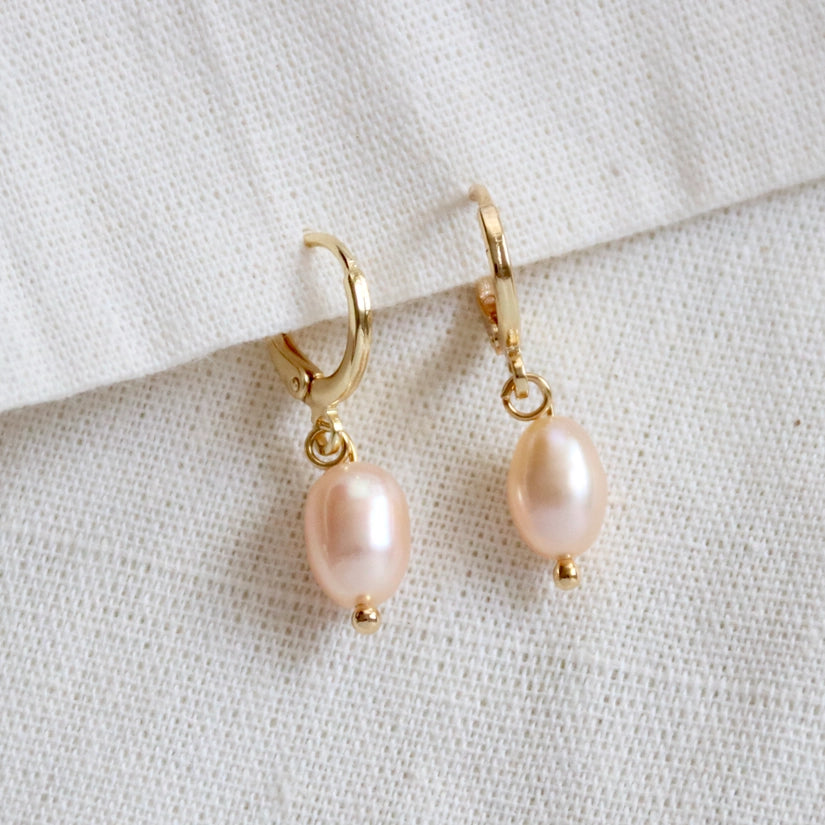 Crafted from high-quality 14K gold-plated material, these earrings are both durable and long-lasting, ensuring they will be a treasured addition to your jewellery collection. The blush pink pearl pendant adds a touch of femininity and glamour, making them the perfect choice for any occasion. It is said that pearls are good for calming your mind and symbolize perfection, good fortune, wealth and good luck.