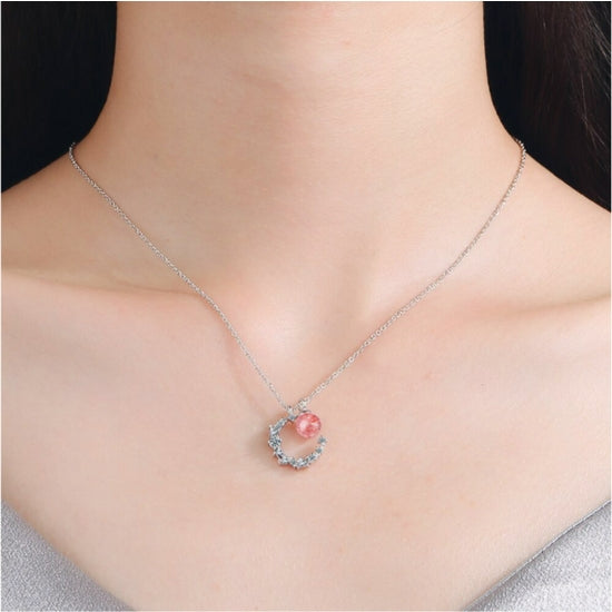 Introducing our stunning Strawberry Crystal Moon Pendant Necklace, handcrafted with natural Strawberry Quartz and a crystal Moon pendant, hanging on a Sterling Silver Chain. This unique necklace is the perfect addition to any jewellery collection and is sure to turn heads.