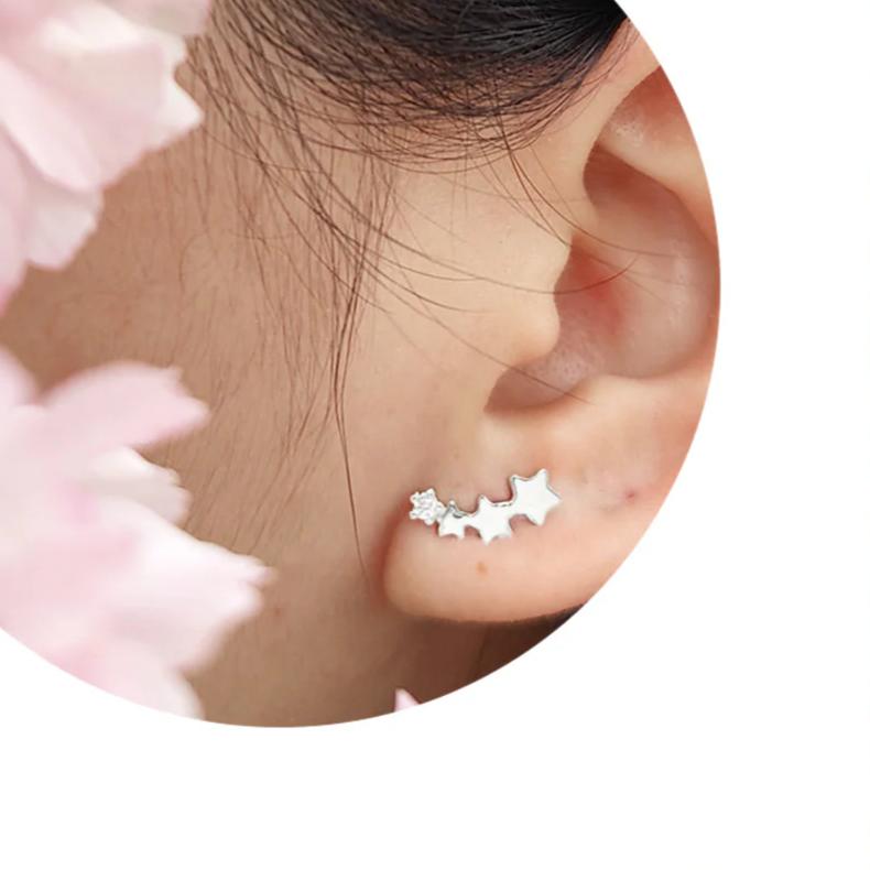 The earrings feature four shooting stars, with three in plain Sterling Silver and one crystal embellished star, creating a striking contrast that catches the eye. The versatile design allows you to wear them as a drop earring for a glamorous evening look or as an upward crawler for everyday wear, making them two styles in one!